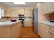 Spacious kitchen includes an island, stainless steel refrigerator, and plenty of cabinet storage at 6307 Laurel Creek Trl, Ellenton, FL 34222
