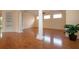 Large living area with hardwood floors, natural light, and decorative columns at 6307 Laurel Creek Trl, Ellenton, FL 34222