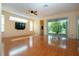Open living area with sliding glass doors, TV, and ceiling fan at 6307 Laurel Creek Trl, Ellenton, FL 34222