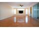Bright living room with wood floors, ceiling fan, and flat screen tv at 6307 Laurel Creek Trl, Ellenton, FL 34222