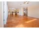 Open floorplan with wood flooring connecting the living room, dining area and kitchen at 6307 Laurel Creek Trl, Ellenton, FL 34222