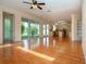 Open floor plan features hardwood floors and an adjacent kitchen and sunroom at 6307 Laurel Creek Trl, Ellenton, FL 34222
