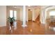 Spacious and elegant living room featuring hardwood floors and decorative columns at 6307 Laurel Creek Trl, Ellenton, FL 34222