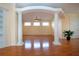 Open-concept living space with hardwood floors, columns, and ample natural light at 6307 Laurel Creek Trl, Ellenton, FL 34222
