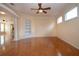 Spacious living room with hardwood floors, ceiling fan, and built-in shelving at 6307 Laurel Creek Trl, Ellenton, FL 34222