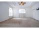 Spacious main bedroom with carpet, ceiling fan, tray ceiling, and three windows with natural lighting at 6307 Laurel Creek Trl, Ellenton, FL 34222