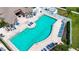 Aerial view of a community pool with sun loungers and umbrellas, surrounded by well-maintained landscaping at 6307 Laurel Creek Trl, Ellenton, FL 34222