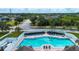 Community pool with lounge chairs, umbrellas, and a white fence for privacy at 6307 Laurel Creek Trl, Ellenton, FL 34222