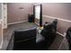 Home theater room featuring comfortable black leather seating, carpeting, and a window with blackout curtains at 6307 Laurel Creek Trl, Ellenton, FL 34222