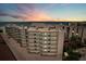 Exterior of the beachfront condo building with multiple balconies overlooking the Gulf at 6480 Midnight Pass Rd # 311, Sarasota, FL 34242