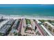 Aerial view of beachfront condos featuring a pool and stunning ocean views at 6480 Midnight Pass Rd # 311, Sarasota, FL 34242
