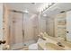 Updated bathroom with a glass shower door and floral wallpaper at 6480 Midnight Pass Rd # 311, Sarasota, FL 34242