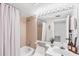 Bathroom featuring a combination shower and tub, well-lit vanity, and neutral tile at 6480 Midnight Pass Rd # 311, Sarasota, FL 34242