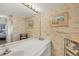 Bathroom vanity featuring floral wallpaper, a large mirror, and classic lighting fixtures creating a vintage aesthetic with ample counter space at 6480 Midnight Pass Rd # 311, Sarasota, FL 34242