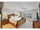 Elegant bedroom featuring an ornate wooden bed and a ceiling fan at 6480 Midnight Pass Rd # 311, Sarasota, FL 34242