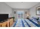 Bright bedroom with a large window, dresser, and a TV at 6480 Midnight Pass Rd # 311, Sarasota, FL 34242