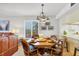 Dining room with wooden table and chairs, adjacent to the living room and kitchen area at 6480 Midnight Pass Rd # 311, Sarasota, FL 34242