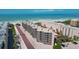 Exterior of condo building featuring garage parking and tiered balconies with ocean views at 6480 Midnight Pass Rd # 311, Sarasota, FL 34242