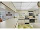 Kitchen with an island, white cabinetry, and black appliances at 6480 Midnight Pass Rd # 311, Sarasota, FL 34242