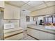 Bright kitchen featuring a microwave, with an inviting view into the adjacent living room at 6480 Midnight Pass Rd # 311, Sarasota, FL 34242