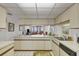 Bright kitchen with white cabinets, a breakfast bar, and modern appliances at 6480 Midnight Pass Rd # 311, Sarasota, FL 34242