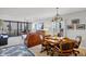 Open living space with dining area, featuring leather furniture and natural light from the balcony at 6480 Midnight Pass Rd # 311, Sarasota, FL 34242