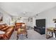 Open living space with a brown leather sofa, flat screen TV, and view to the kitchen area at 6480 Midnight Pass Rd # 311, Sarasota, FL 34242