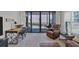 Well-lit living room with a wooden desk and balcony access overlooking the ocean at 6480 Midnight Pass Rd # 311, Sarasota, FL 34242