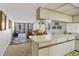 Open-concept view of the living room from the kitchen, featuring balcony access and comfortable seating at 6480 Midnight Pass Rd # 311, Sarasota, FL 34242