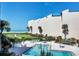 The community pool with manicured landscaping and beach views at 6480 Midnight Pass Rd # 311, Sarasota, FL 34242