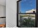 Serene view from a window showcasing the pool and beach, complemented by lush palm trees at 6480 Midnight Pass Rd # 311, Sarasota, FL 34242