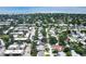 The aerial shot captures a tranquil neighborhood with tree-lined streets and varied property types at 6760 14Th S St, St Petersburg, FL 33705