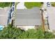 This aerial shot showcases the roof, partial backyard and surrounding greenery of the property at 6760 14Th S St, St Petersburg, FL 33705