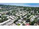 The aerial view showcases a community of residential buildings, tennis courts, and tree-lined streets at 6760 14Th S St, St Petersburg, FL 33705