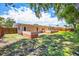 A large backyard with a block seating area and fenced perimeter at 6760 14Th S St, St Petersburg, FL 33705