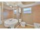 Bright bathroom with pedestal sink, tile flooring and large mirror at 6760 14Th S St, St Petersburg, FL 33705