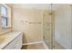 Bathroom featuring vanity with marble top, and a walk-in shower with glass doors at 6760 14Th S St, St Petersburg, FL 33705