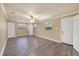 A well-lit bedroom featuring wood-look floors, neutral paint, and two windows at 6760 14Th S St, St Petersburg, FL 33705