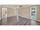 Neutral bedroom featuring wood-look floors, recessed lights, and a view from two windows at 6760 14Th S St, St Petersburg, FL 33705