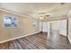 The bedroom includes wood-look floors, neutral paint, windows, and doorways to other rooms at 6760 14Th S St, St Petersburg, FL 33705