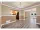 Dining area with wood flooring, updated lighting, and a view of the kitchen and backyard at 6760 14Th S St, St Petersburg, FL 33705
