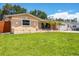 Charming single-story home with well-maintained lawn, palm trees, and an attached two-car garage at 6760 14Th S St, St Petersburg, FL 33705