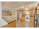 Efficient kitchen with wooden cabinetry, laminate counters, track lighting, and wood flooring at 6760 14Th S St, St Petersburg, FL 33705