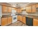 Traditional kitchen featuring wood cabinets, modern appliances, and a stylish countertop at 6760 14Th S St, St Petersburg, FL 33705