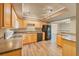 Well-lit kitchen featuring wood cabinetry, laminate counters, wood flooring, and a black refrigerator at 6760 14Th S St, St Petersburg, FL 33705