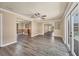 An open-plan living room featuring wood-look floors, recessed lights and a fan at 6760 14Th S St, St Petersburg, FL 33705