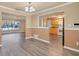 Open living area with wood floors and a view into the living room, kitchen, and front yard at 6760 14Th S St, St Petersburg, FL 33705