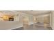 Open-concept living space with wood flooring, a mirrored wall, and a pass-through to the kitchen at 6760 14Th S St, St Petersburg, FL 33705