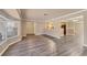 Bright living room featuring wood floors, a bay window, and views into the kitchen and dining area at 6760 14Th S St, St Petersburg, FL 33705