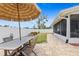 Fenced backyard with paved area and access to the screened porch at 6841 Roxbury Dr, Sarasota, FL 34231